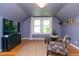 Comfortable bonus room featuring hardwood floors, natural light, and comfortable seating at 828 N Butler Ave, Indianapolis, IN 46219