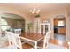 A dining room showing the wood table and chairs, chandelier and open access to living and kitchen at 828 N Butler Ave, Indianapolis, IN 46219