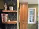 Close up of the kitchen showcasing floating shelves, plants, geometric backsplash and wood cabinets at 828 N Butler Ave, Indianapolis, IN 46219