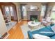 Open living area featuring hardwood floors, stylish furniture, and an adjacent dining space at 828 N Butler Ave, Indianapolis, IN 46219