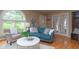 Inviting living room with hardwood floors, modern furniture, and large windows providing natural light at 828 N Butler Ave, Indianapolis, IN 46219