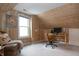 A cozy office space with wood paneling, a large window, and a comfortable chair at 828 N Butler Ave, Indianapolis, IN 46219