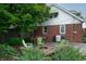 Backyard patio with outdoor seating, fire pit, landscaping, and string lights at 828 N Butler Ave, Indianapolis, IN 46219