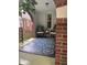 Cozy covered porch with seating area, plants, and a stylish patterned rug creating a relaxing outdoor space at 828 N Butler Ave, Indianapolis, IN 46219