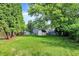 Spacious backyard featuring a shed, lush greenery, and potential for outdoor activities and relaxation at 8920 Caminito Rd, Indianapolis, IN 46234