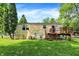Backyard view of a house with a wood deck and fenced yard at 8920 Caminito Rd, Indianapolis, IN 46234