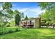 A house with a deck in the backyard surrounded by lush greenery at 8920 Caminito Rd, Indianapolis, IN 46234