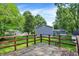 Backyard view from the wooden deck, showcasing a serene outdoor space with greenery and a glimpse of the house at 8920 Caminito Rd, Indianapolis, IN 46234
