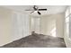 Bedroom featuring a ceiling fan, window, and ample closet space for storage at 8920 Caminito Rd, Indianapolis, IN 46234