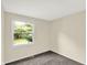 Well-lit bedroom featuring a window overlooking the outdoors at 8920 Caminito Rd, Indianapolis, IN 46234