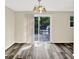 Bright dining area with backyard access, chandelier, and wood floors, perfect for Gathering meals and entertaining at 8920 Caminito Rd, Indianapolis, IN 46234