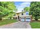 Split-level home featuring a two-car garage, siding, and landscaped front yard at 8920 Caminito Rd, Indianapolis, IN 46234