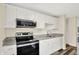 Modern kitchen with stainless steel appliances, granite countertops, and white cabinets, ideal for cooking at 8920 Caminito Rd, Indianapolis, IN 46234