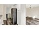 Open kitchen area with black refrigerator, wood floors and white cabinets, offering both style and functionality at 8920 Caminito Rd, Indianapolis, IN 46234