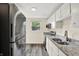 Modern kitchen with stainless steel appliances, granite countertops, and window view at 8920 Caminito Rd, Indianapolis, IN 46234