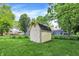 Backyard shed offers extra storage space on a lush green lawn at 8920 Caminito Rd, Indianapolis, IN 46234