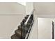 Carpeted staircase with white railing and black metalwork at 8920 Caminito Rd, Indianapolis, IN 46234