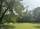 Expansive green backyard with mature trees, offering a private and serene setting at 9011 Camby Rd, Camby, IN 46113