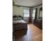 Bedroom with hardwood flooring, natural light, traditional molding and a decorative wallpaper border at 9011 Camby Rd, Camby, IN 46113