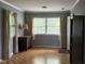 Sunny bedroom with light grey walls, hardwood floors, and two windows dressed with beautiful curtains at 9011 Camby Rd, Camby, IN 46113