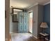 Inviting entryway featuring a blue front door, stylish decor, and hardwood floors with a rug at 9011 Camby Rd, Camby, IN 46113