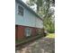 Two-story home with brick and siding exterior, accented with blue shutters and mature landscaping at 9011 Camby Rd, Camby, IN 46113