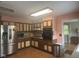 Functional kitchen featuring stainless steel appliances, neutral countertops, and wood cabinetry at 9011 Camby Rd, Camby, IN 46113