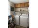 Functional laundry room featuring white washer and dryer, storage cabinets, and plenty of space at 9011 Camby Rd, Camby, IN 46113