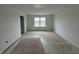 Unfinished bedroom featuring white walls and trim with a large window overlooking the backyard pond at 9137 Steinbeck Ln, Indianapolis, IN 46239