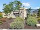 Edgewood Farms community entrance featuring a stone sign, wrought iron fence, and landscaped bushes at 9137 Steinbeck Ln, Indianapolis, IN 46239