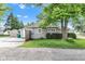 View of the back of the property featuring a wooden deck, tidy landscaping and gravel drive, providing a private retreat at 917 W Pearl St, Lebanon, IN 46052