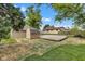 Landscaped backyard with gravel pad, storage shed, and mature trees, providing a serene outdoor setting at 917 W Pearl St, Lebanon, IN 46052