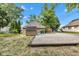 Spacious backyard featuring a shed, gravel area, lush greenery, and natural wood border offering outdoor charm at 917 W Pearl St, Lebanon, IN 46052