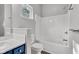 Bright bathroom features tiled walls, a shower-tub combo and a blue vanity at 917 W Pearl St, Lebanon, IN 46052