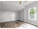 Bright bedroom features wood-look flooring, a ceiling fan, and large window letting in natural light at 917 W Pearl St, Lebanon, IN 46052