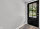 Modern entryway featuring sleek black door with glass window, offering a bright and inviting welcome at 917 W Pearl St, Lebanon, IN 46052