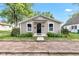 Charming single-story home featuring neutral siding and a quaint entrance with a brick path and manicured landscaping at 917 W Pearl St, Lebanon, IN 46052