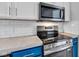 Modern kitchen features stainless steel appliances, gray countertops, and white subway tile for a sleek design at 917 W Pearl St, Lebanon, IN 46052