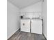 Functional laundry area with washer, dryer, and beadboard walls offers a practical space for household chores at 917 W Pearl St, Lebanon, IN 46052