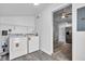 Bright laundry area with washer, dryer, and storage, connecting seamlessly to the kitchen, enhancing convenience and functionality at 917 W Pearl St, Lebanon, IN 46052