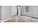 Well-lit living room with laminate flooring, black door with window and large window at 917 W Pearl St, Lebanon, IN 46052