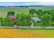 An aerial view capturing a charming two-story home nestled among trees, adjacent to farmland, and a red barn at 9237 N 500 W, Fountaintown, IN 46130
