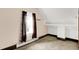 Attic room featuring neutral walls and carpet and a window with brown curtains at 9237 N 500 W, Fountaintown, IN 46130