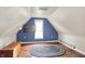 Cozy attic featuring blue accent wall, area rug, mounted tv, and natural light at 9237 N 500 W, Fountaintown, IN 46130
