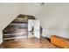 Attic featuring wood flooring, wood accent wall, chest, and a view into another room at 9237 N 500 W, Fountaintown, IN 46130