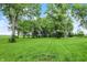 Lush backyard featuring a well-maintained lawn and mature trees, providing a serene outdoor space at 9237 N 500 W, Fountaintown, IN 46130