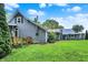Expansive backyard featuring lush green lawn and a charming gray home with metal roof and wooden deck at 9237 N 500 W, Fountaintown, IN 46130