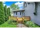 Backyard featuring a wooden deck and a well-maintained lawn with surrounding greenery at 9237 N 500 W, Fountaintown, IN 46130