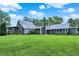 Lush backyard with well-kept lawn, showcasing a charming gray home under a bright sky with scattered clouds at 9237 N 500 W, Fountaintown, IN 46130