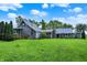 Spacious backyard showcasing a gray home with well-maintained lawn and mature trees at 9237 N 500 W, Fountaintown, IN 46130